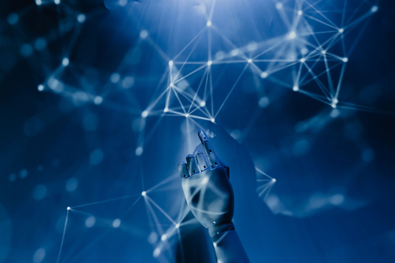 A robotic hand reaching toward a glowing network, representing an AI receptionist answering enquiries