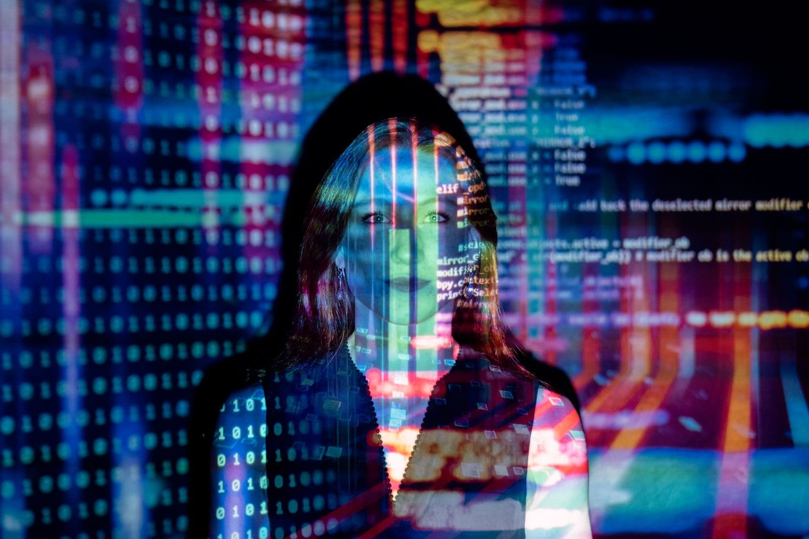 A person surrounded by projected code and data, representing the architecture decisions behind an AI stack